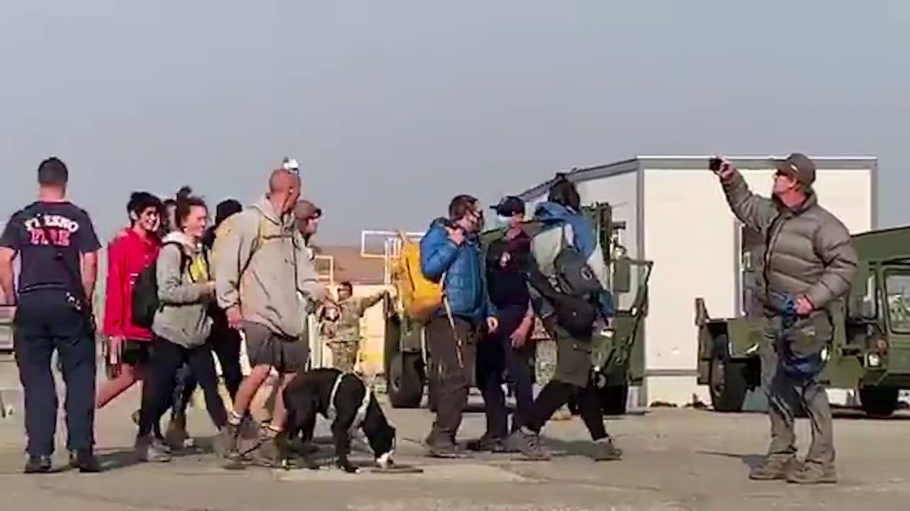 Some of the people airflifted from the forest by the National Guard arrive at the Fresno Yosemite International Airport on Tuesday.