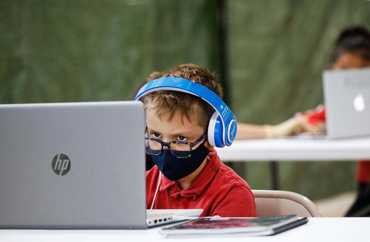 Third-grade student Jackson Gebelin focuses on an online class as he sits at a desk at the Delano Recreation Center in Los Angeles on September 3.