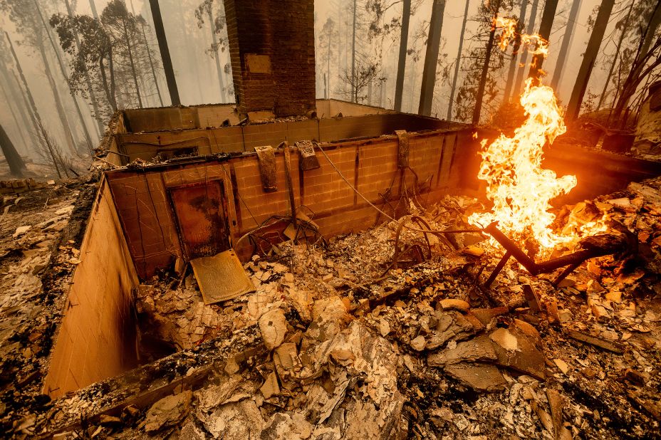 Flames burn at a home leveled by the Creek Fire in Fresno County, California.