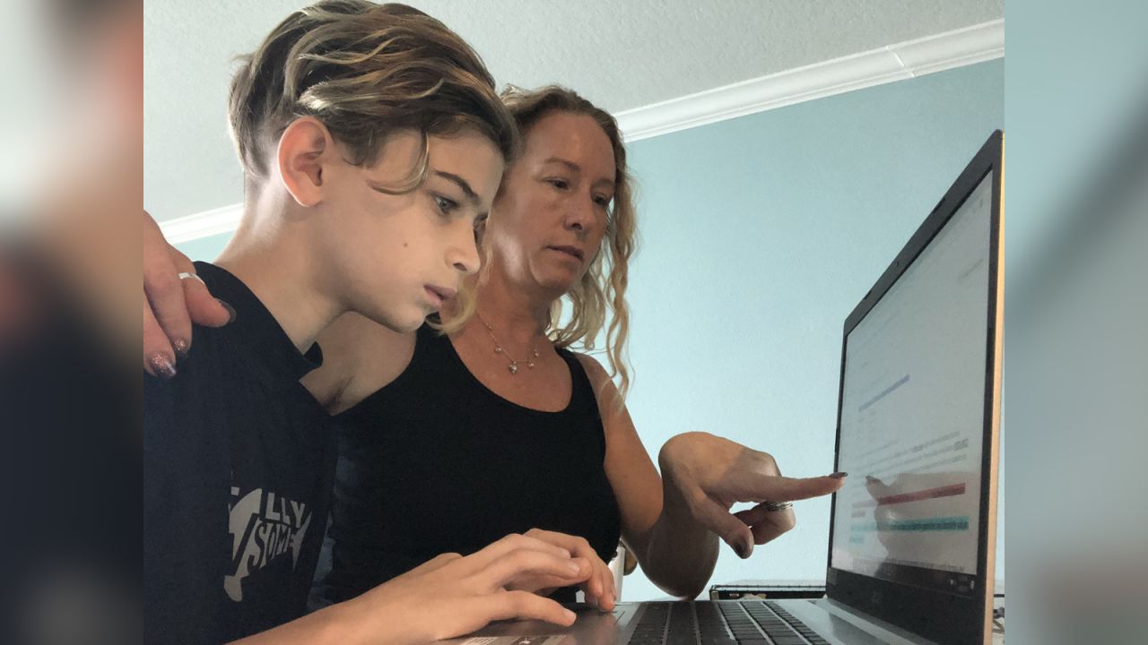 Raquel Minina assists 11-year-old son Syrus with his lessons.