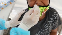 A boy receives a free COVID-19 test at a St. John's Well Child & Family Center mobile clinic set up outside Walker Temple AME Church in South Los Angeles amid the coronavirus pandemic on July 15, 2020 in Los Angeles, California. 