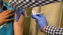 A man receives an injection as UCLA and AstraZeneca begin phase three trials in a potential COVID-19 vaccine.