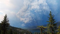 Plumes of smoke rise into the sky as a wildfire burns on the hills near Shaver Lake, Calif., Saturday, Sept. 5, 2020. Fires in the Sierra National Forest have prompted evacuation orders as authorities urged people seeking relief from the Labor Day weekend heat wave to stay away from the popular lake. (Eric Paul Zamora/The Fresno Bee via AP)