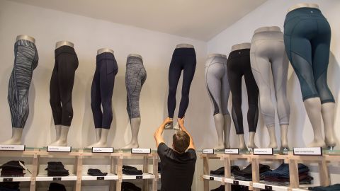 An employee moves a mannequin displaying a pair of leggings at the Lululemon Athletica Inc. sports apparel store on Regent Street in London, U.K., on Thursday, July 27, 2017. Lululemon is trying to attract more male customers and expand its presence overseas while competitors increase their reliance on discounts. Photographer: Simon Dawson/Bloomberg via Getty Images