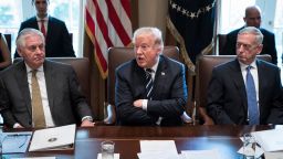 President Donald Trump, flanked by Secretary of State Rex Tillerson, left, and Secretary of Defense Jim Mattis, right,  speaks during a cabinet meeting in the Cabinet Room of the White House in Washington, DC on Monday, Oct. 16, 2017. 