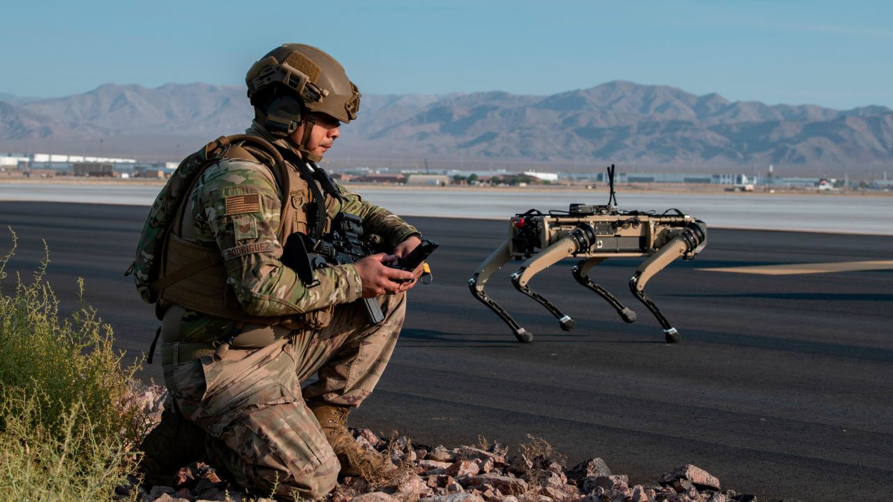 Tech. Sgt. John Rodiguez, 321st Contingency Response Squadron security team, provides security with a Ghost Robotics Vision 60 prototype at a simulated austere base during the Advanced Battle Management System exercise on Nellis Air Force Base, Nevada, Sept. 1, 2020. The ABMS is an interconnected battle network - the digital architecture or foundation - which collects, processes and shares data relevant to warfighters in order to make better decisions faster in the kill chain. In order to achieve all-domain superiority, it requires that individual military activities not simply be de-conflicted, but rather integrated -- activities in one domain must enhance the effectiveness of those in another domain. (U.S. Air Force photo by Tech. Sgt. Cory D. Payne)
