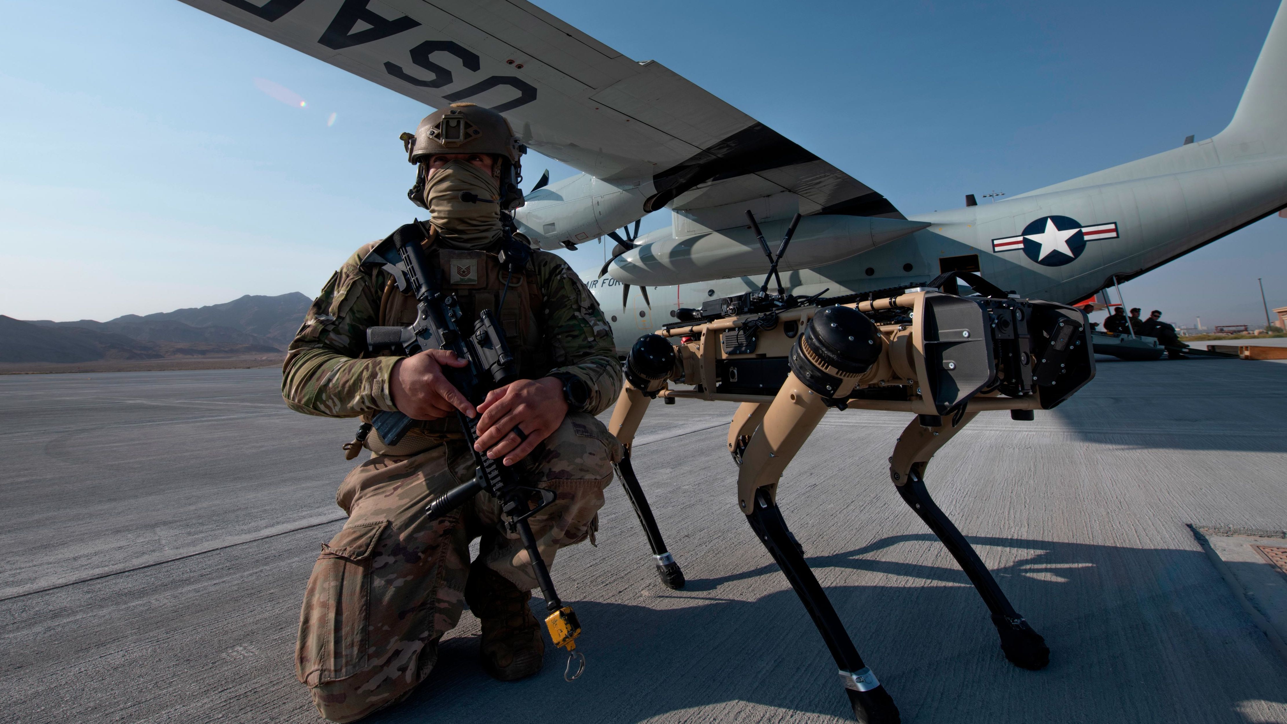 US Air Force Tech. Sgt. John Rodiguez provides security with a Ghost Robotics Vision 60 prototype during an exercises on Nellis Air Force Base in Nevada.
