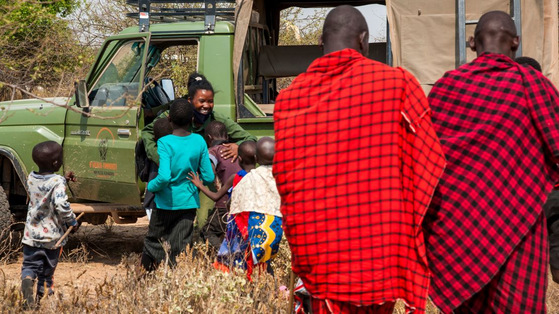 Children run to welcome Purity Amleset Lakara, a member of the all-female IFAW-supported Team Lioness on her arrival at her home village in Meshenani, Amboseli, in Kenya.