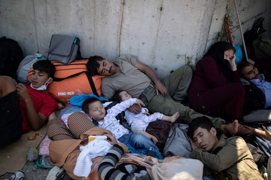 Families sleep next to a road in the aftermath of the fire.