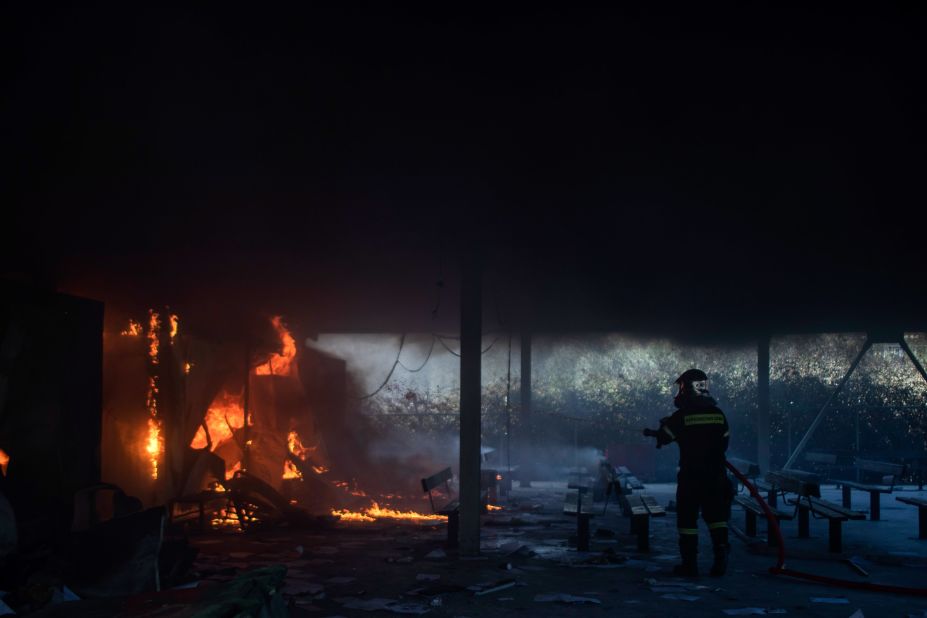 A firefighter works to extinguish the blaze.