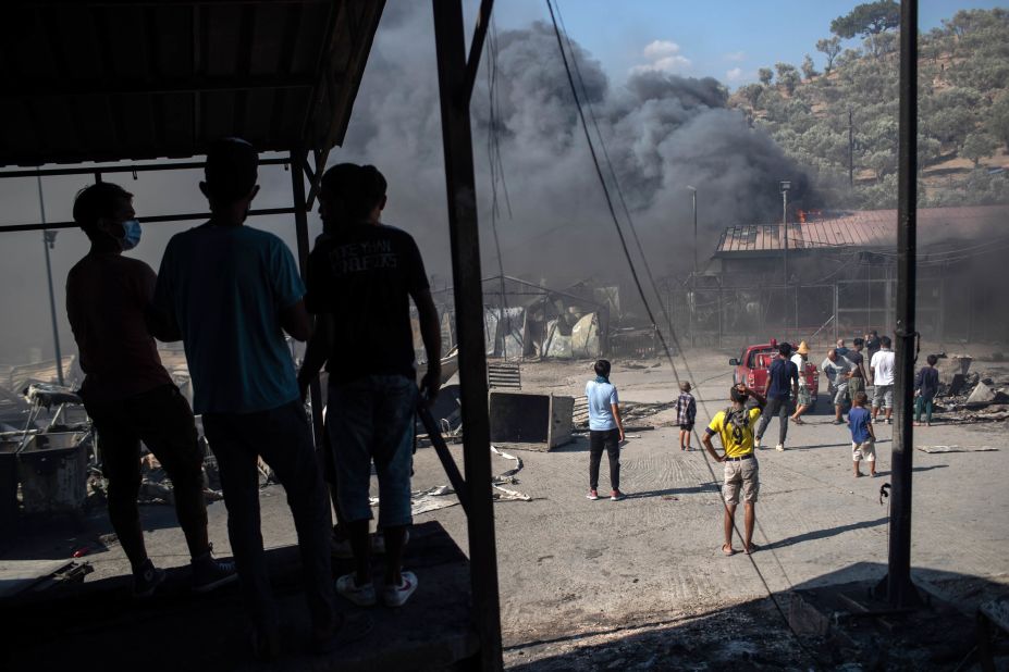 Smoke billows from burning containers used to house migrants.
