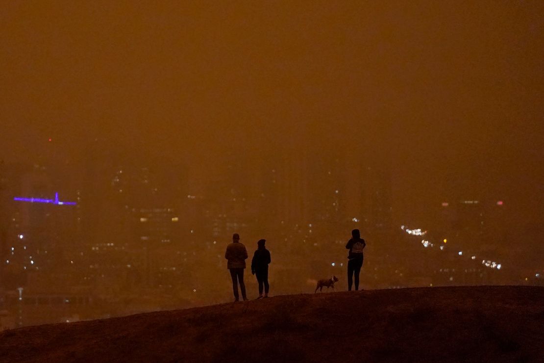 People look toward the skyline obscured by wildfire smoke in daytime from Kite Hill Open Space in San Francisco on September 9.