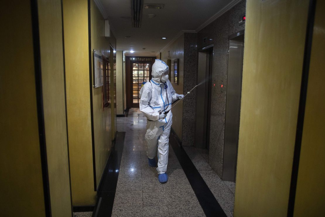 A member of the medical staff disinfects the corridors of a hotel where suspected Covid-19 patients are staying on July 20 in Caracas, Venezuela. 