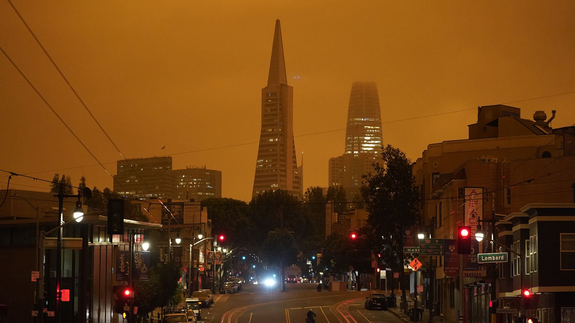 Looking up San Francisco's Columbus Avenue, the Transamerica Pyramid and Salesforce Tower are covered with smoke from nearby wildfires on September 9, 2020. This photo was taken in the late morning.