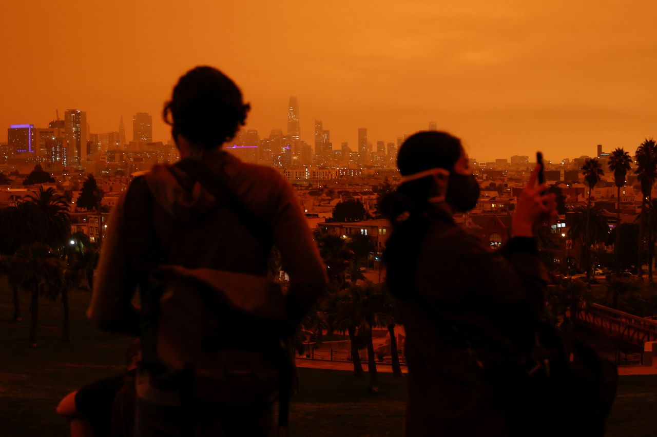 Visitors of San Francisco's Dolores Park are seen under an orange sky <a href="https://www.cnn.com/2020/09/09/weather/california-orange-skies-wildfires-photos-trnd/index.html" target="_blank">darkened by smoke</a> on September 9.
