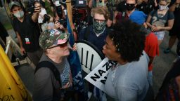 STONE MOUNTAIN, GA - AUGUST 15: A woman argues with a far-right protester during a rally on August 15, 2020 near the downtown of Stone Mountain, Georgia. Georgia's Stone Mountain Park which is famous for its large rock carving of Confederate leaders planned to close on Saturday in response to a planned right-wing rally. (Photo by Lynsey Weatherspoon/Getty Images)