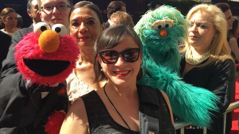 Author Ali Velez Alderfer (center) shares a moment with "Sesame Street" cast members: (from left) Elmo, played by puppeteer Ryan Dillon; Sonia Manzano, who played Maria from 1971 to 2015 and was honored with the Lifetime Achievement Award at the Annual Daytime Emmy Awards in 2016; and Rosita, played by puppeteer Carmen Osbahr.