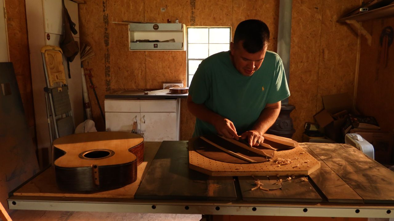 Earl Moore works on a guitar he made from scratch. He credits wood working, in large part, for eight years of sobriety. 