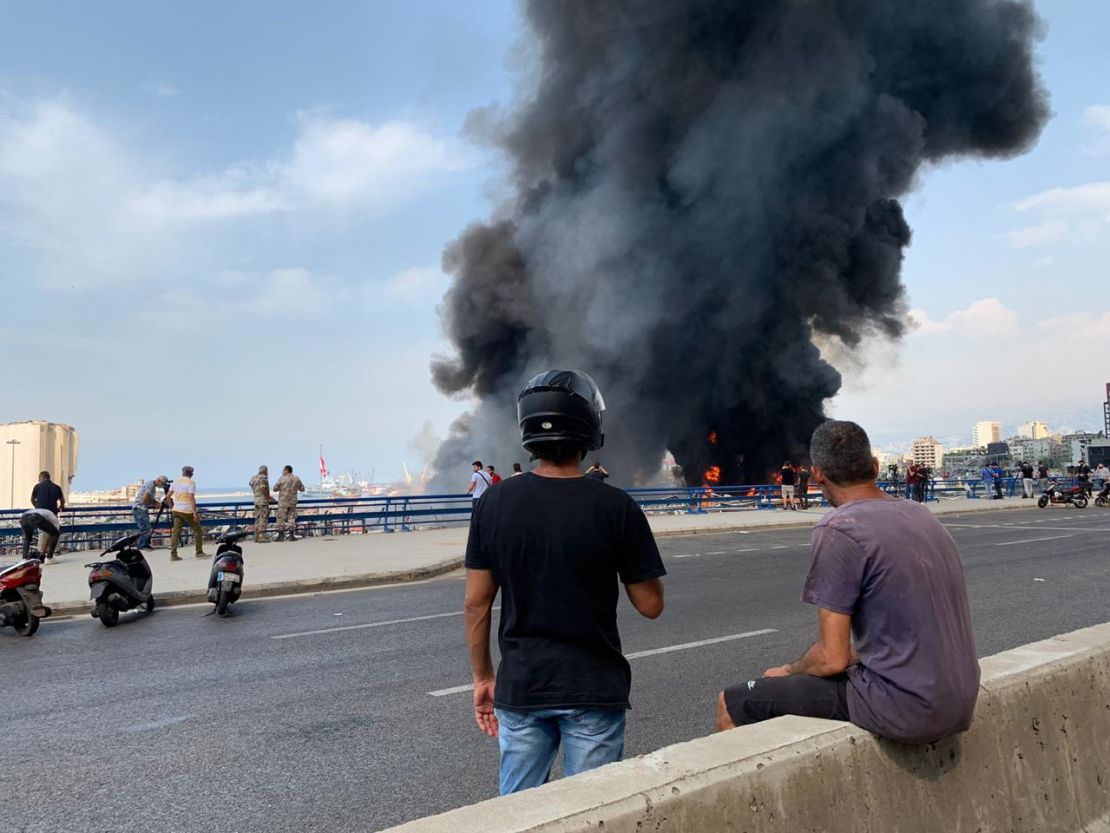 Onlookers watch the blaze near the port.