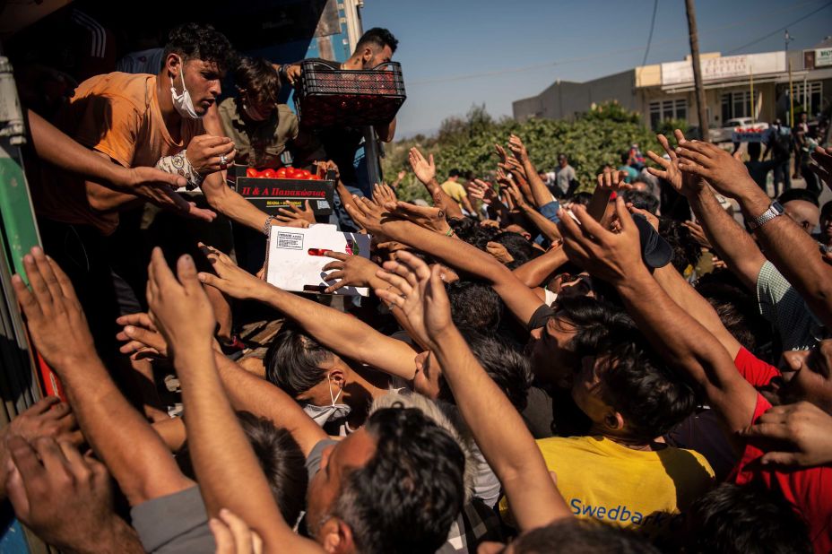 People jostle for food being distributed on September 10.