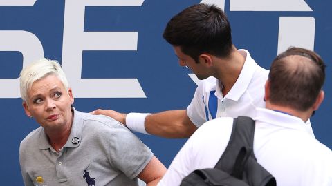Djokovic tends to the line judge who was hit with the ball.