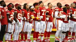 KANSAS CITY, MISSOURI - SEPTEMBER 10: Members of the Kansas City Chiefs stand united for with locked arms before the start of a gam against the Houston Texans at Arrowhead Stadium on September 10, 2020 in Kansas City, Missouri. (Photo by Jamie Squire/Getty Images)