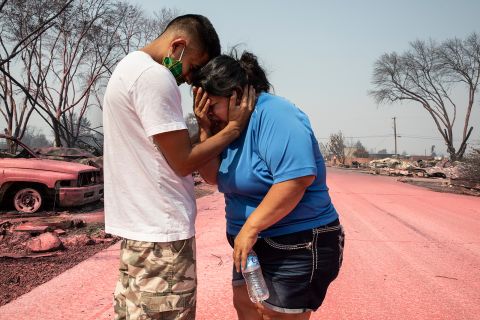 Dora Negrete is consoled by her son Hector Rocha after seeing their destroyed mobile home in Talent, Oregon, on September 10.