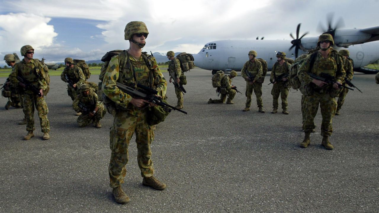 Reinforcements of Australian Army personnel arrive at Honiara Airport during police operation 'Helpem Fren' to restore peace to the Solomon Islands, 23 December 2004. 