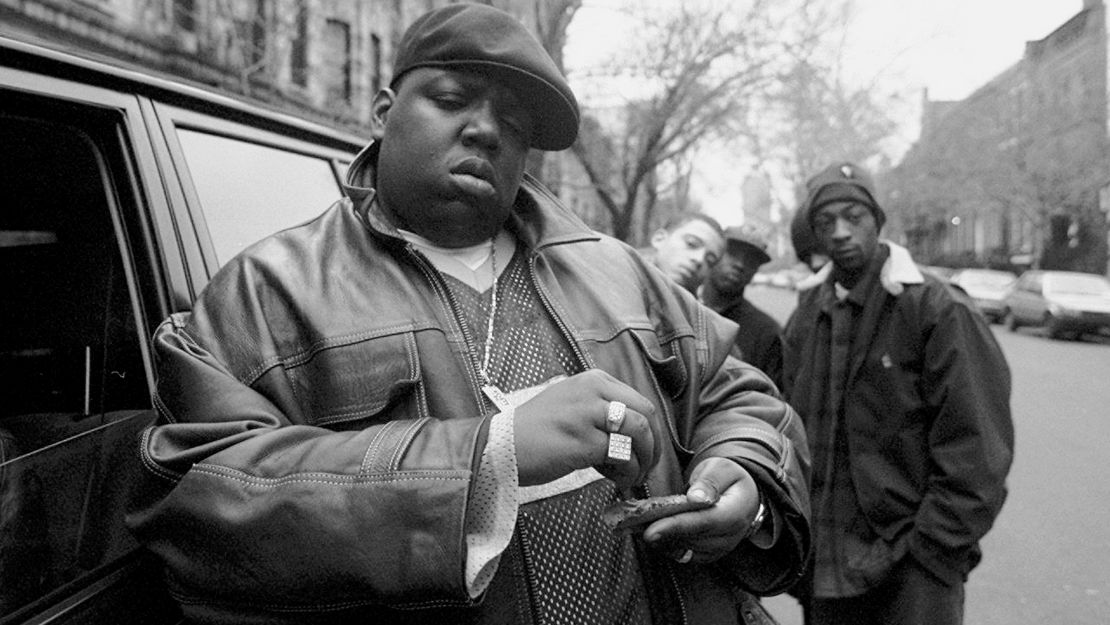 Notorious B.I.G., aka Biggie Smalls, aka Chris Wallace rolls a cigar outside his mother's house in Brooklyn. 