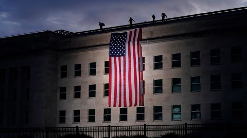 A large American flag is unfurled at the Pentagon ahead of ceremonies at the National 9/11 Pentagon Memorial honoring the 184 people killed there.