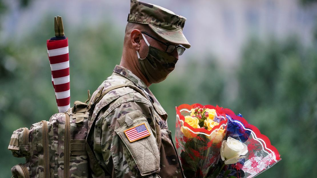 US Army Sgt. Edwin Morales leaves  flowers for fallen FDNY firefighter Ruben D. Correa at the National September 11 Memorial & Museum.