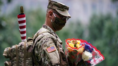 US Army Sgt. Edwin Morales leaves flowers for fallen FDNY firefighter Ruben D. Correa at the National September 11 Memorial & Museum.
