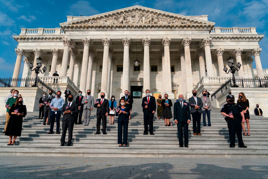 US House Speaker Nancy Pelosi, center, leads House members in a moment of silence at the US Capitol in Washington, DC.