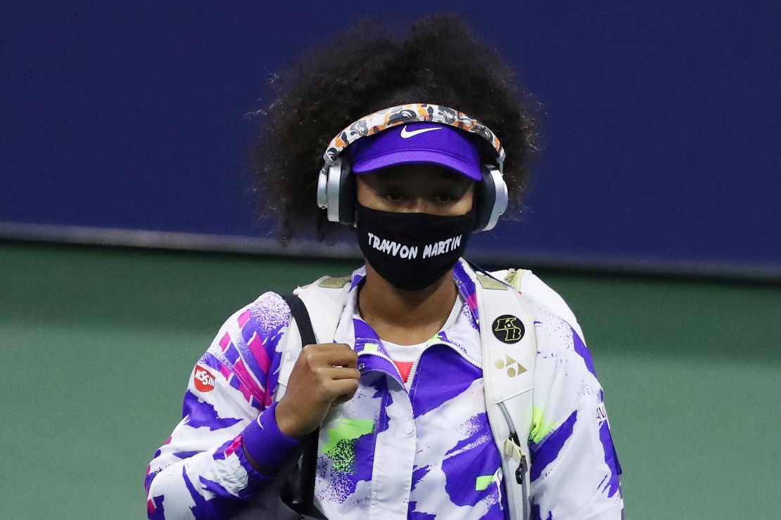 Osaka walks out wearing a mask with Martin's name before taking on Anett Kontaveit.