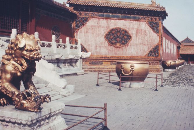 A lion statue guards a doorway in the Forbidden City, circa 1965.  