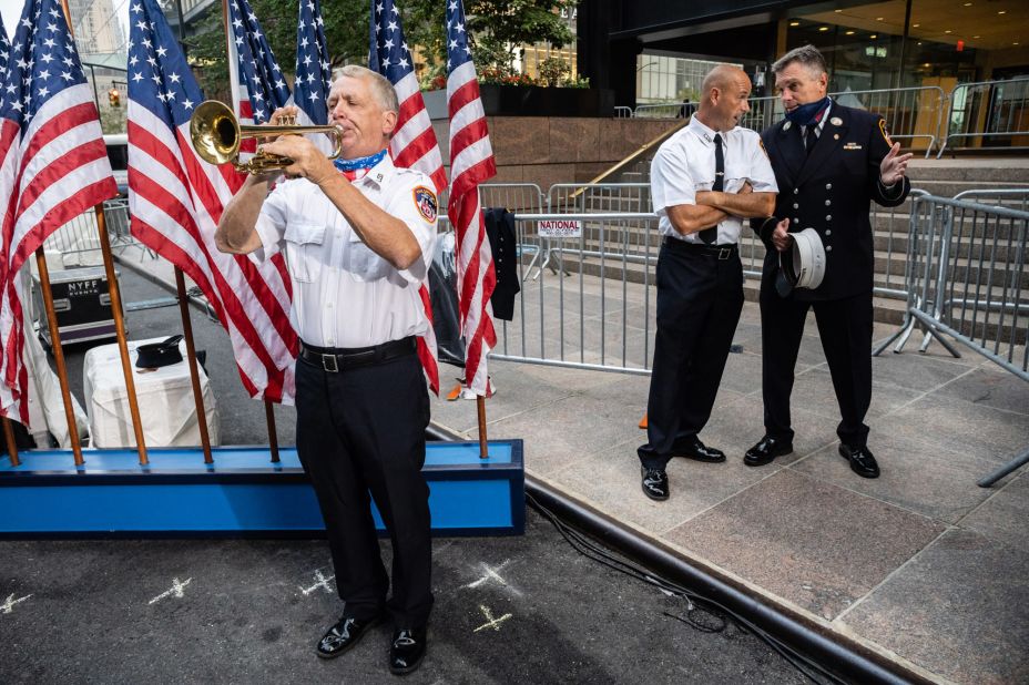 A firefighter bugler practices prior to the start of the Tunnel to Towers ceremony.