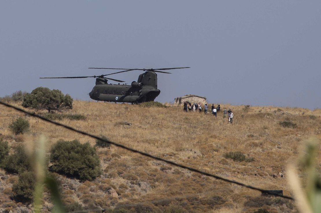 A military helicopter atop a hill on the Greek island of Lesbos on Friday, as police were deployed to the site of a new refugee camp. 