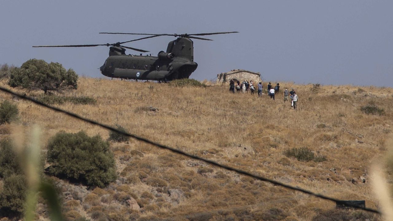 A military helicopter atop a hill on the Greek island of Lesbos on Friday, as police were deployed to the site of a new refugee camp. 