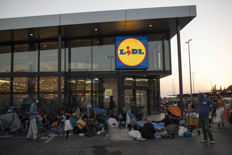Migrants gather outside a Lesbos supermarket on September 11.