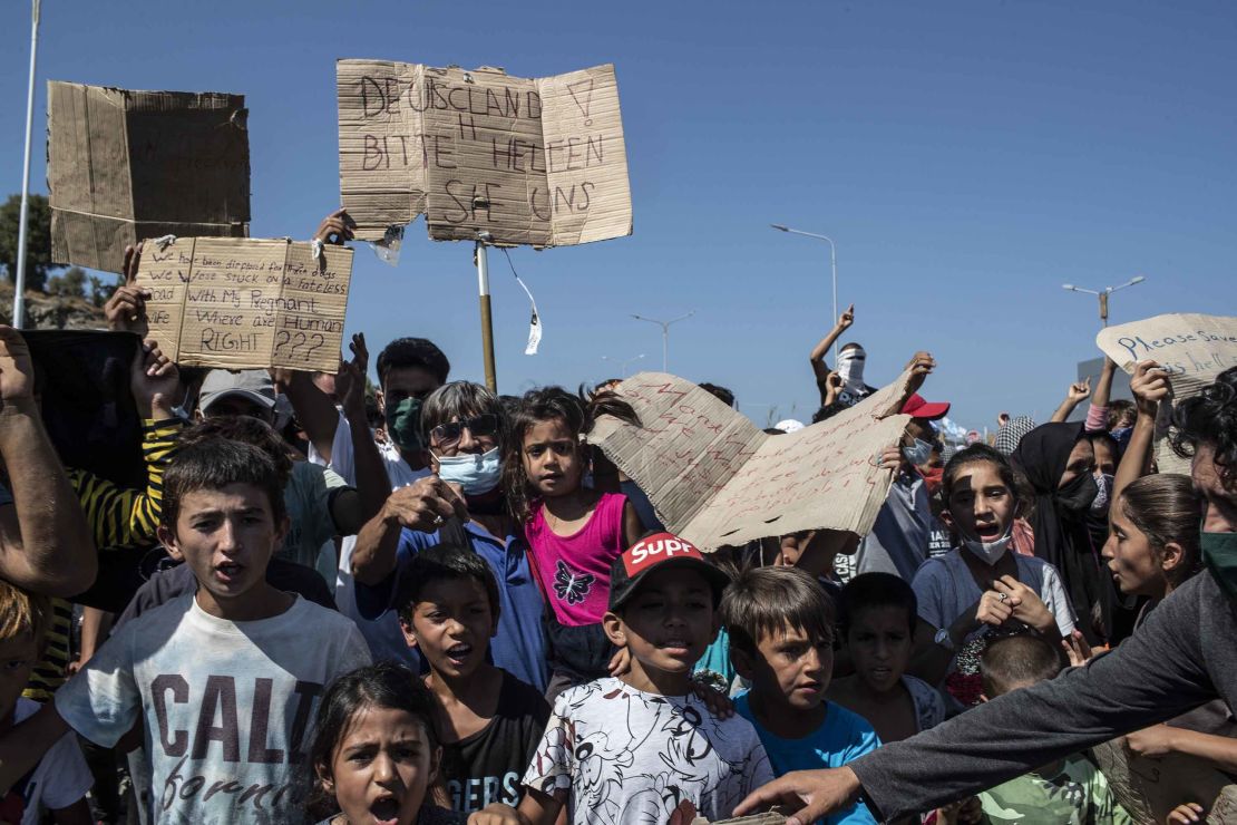 Migrants hold up a banner at a protest Friday as they call for assistance from Europe.