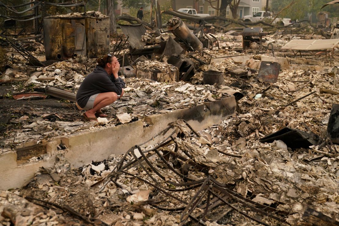 Desiree Pierce cries as she visits her home destroyed by the Almeda Fire in Talent, Oregon, on Friday, Sept. 11, 2020. "I just needed to see it, to get some closure," she said.