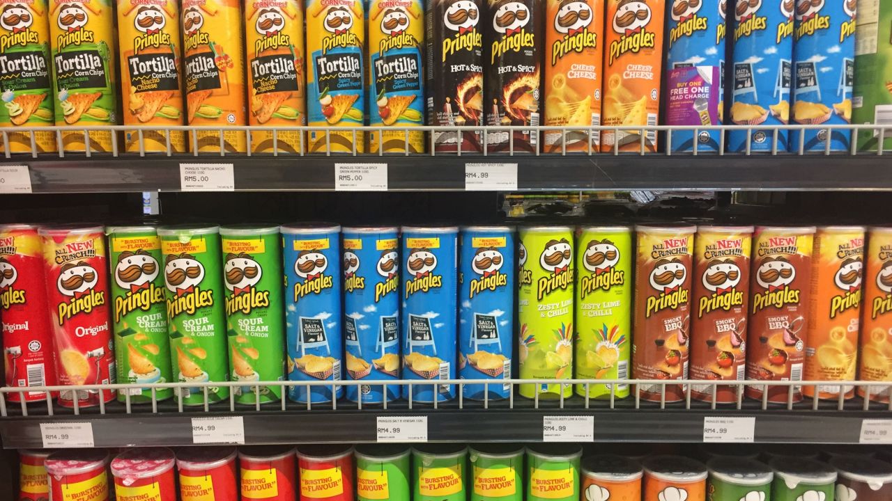 Pringles cans sit on the shelf of a grocery store.