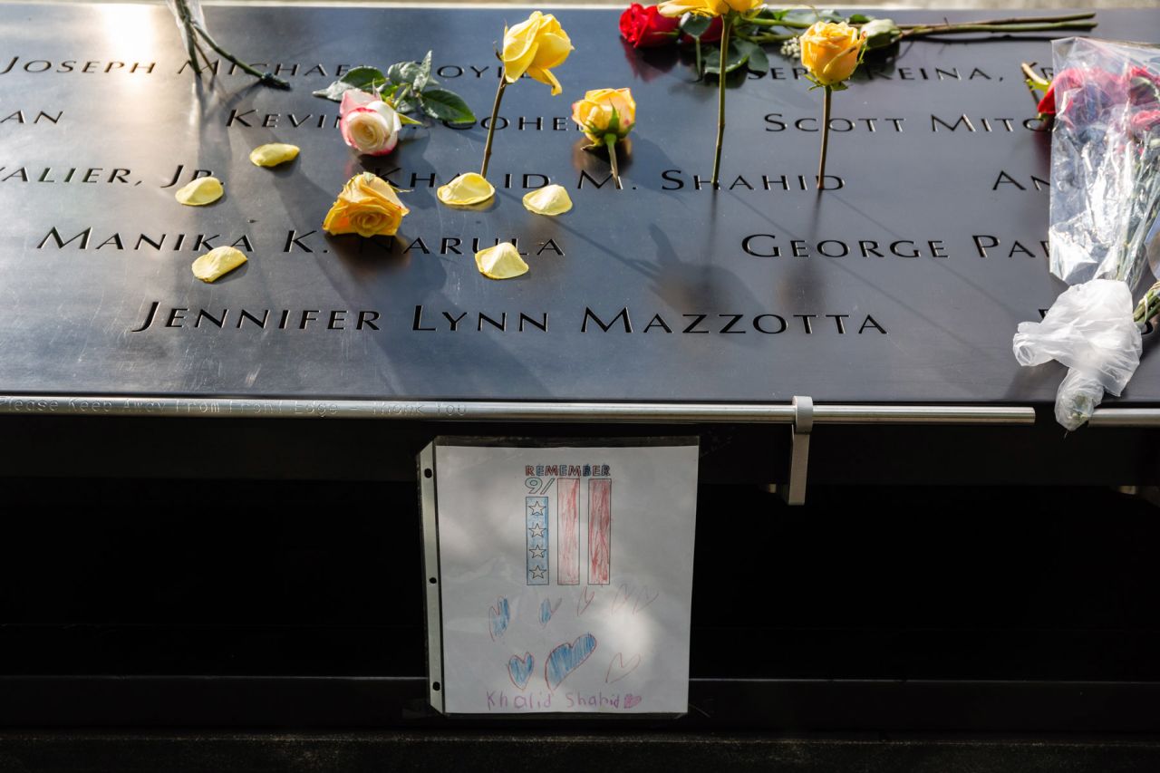 Flowers and a drawing are placed at the 9/11 Memorial.