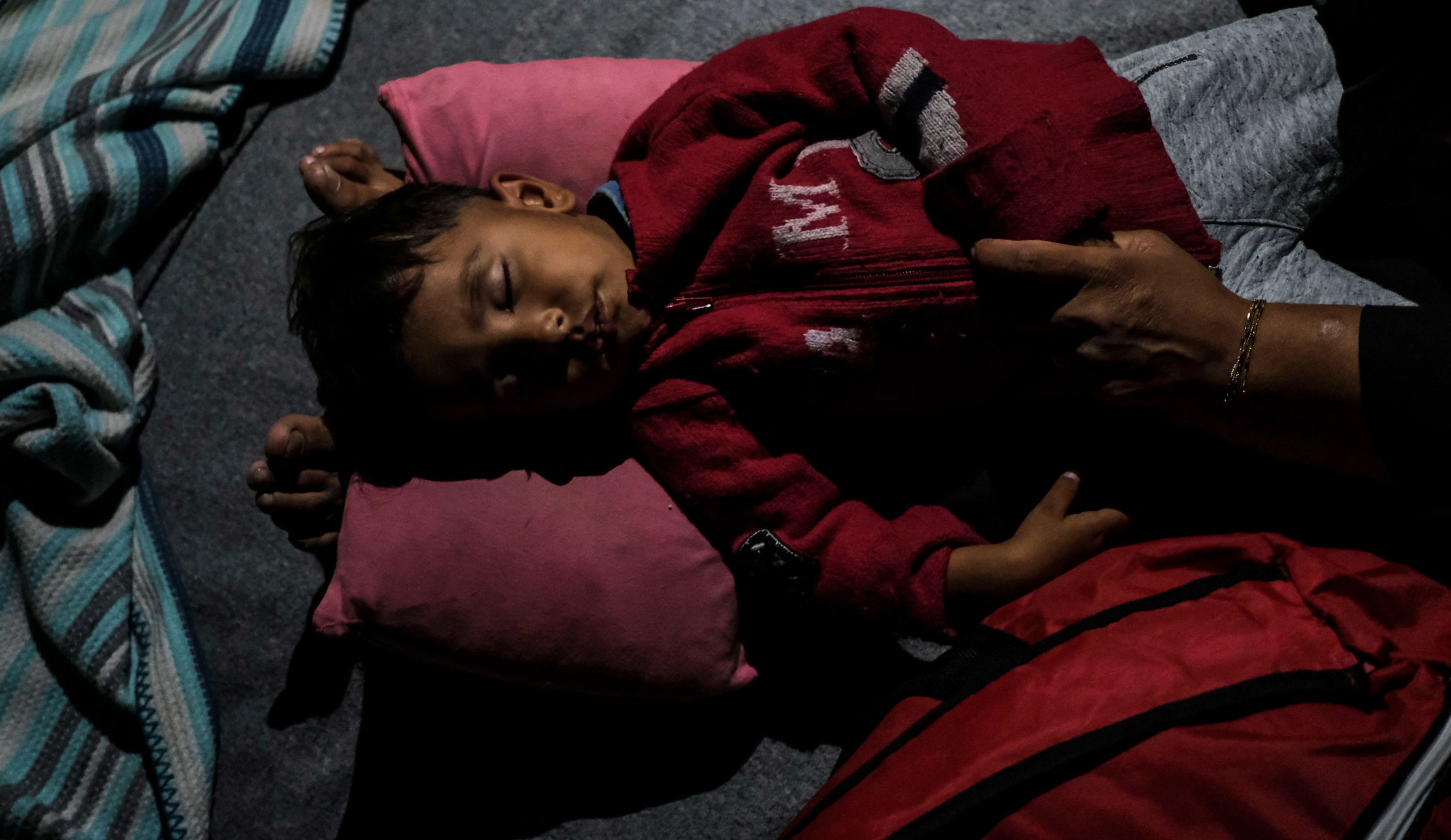 An Afghan child rests after fires broke out in the Moria migrant camp on Tuesday, September 9.