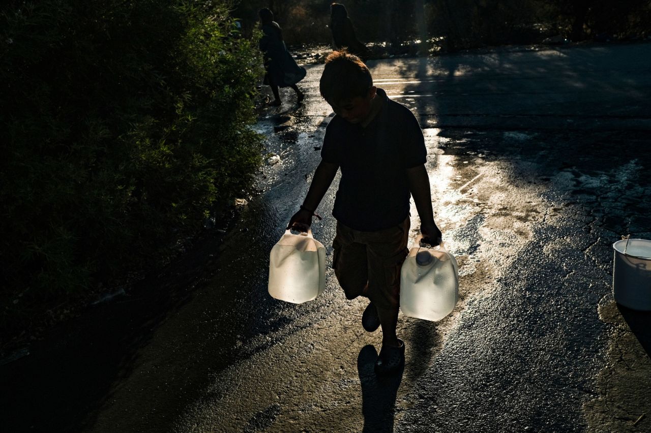 A boy fetches water for his family.
