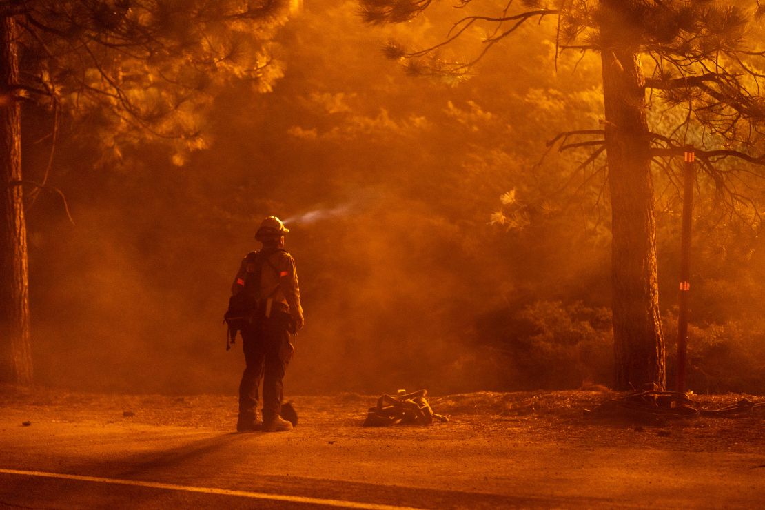 A firefighter watches flames near the Angeles Crest Highway at the Bobcat Fire north of Monrovia, California, on Friday.