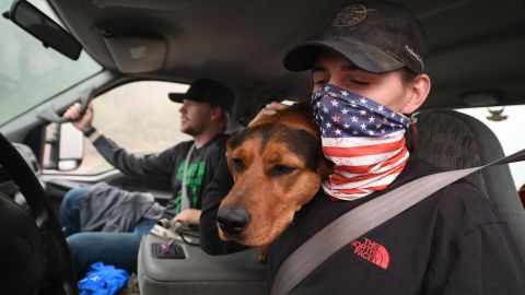 James Smith hugs his dog, Rose, after returning to his evacuated home in Estacada, Oregon, on Saturday.