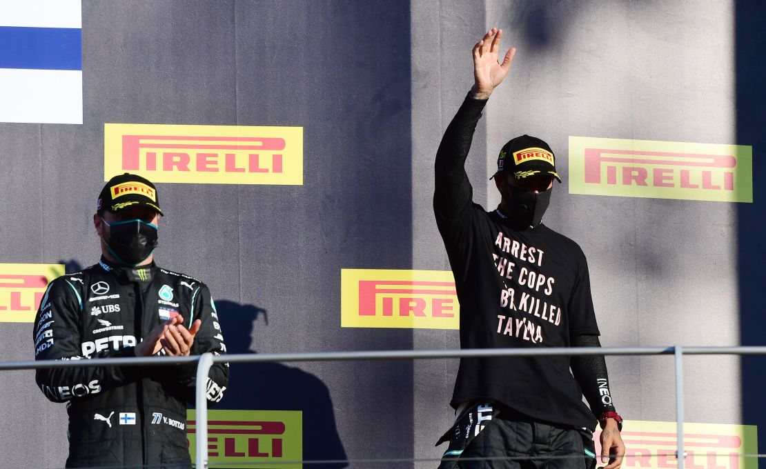 Lewis Hamilton celebrates on the podium wearing a shirt in tribute to the late Breonna Taylor.