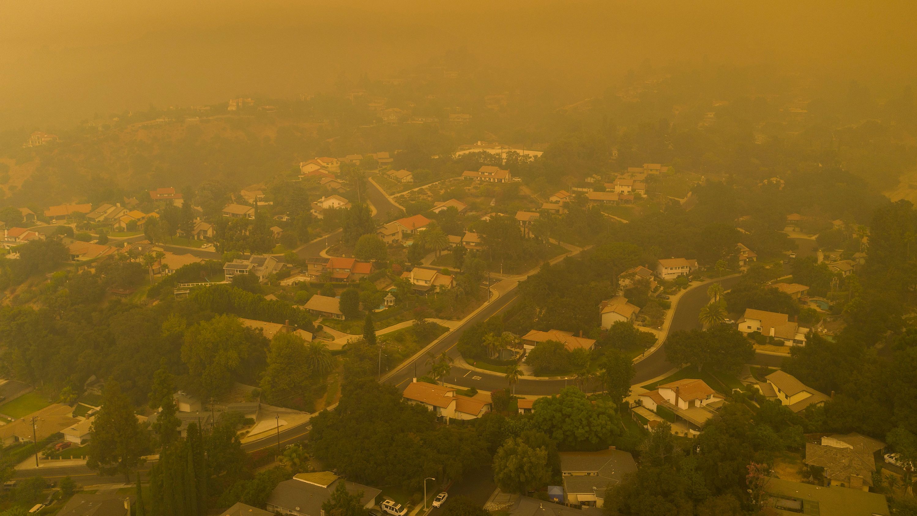 An aerial view shows neighborhoods in Monrovia, California shrouded in smoke as the Bobcat Fire advanced on September 13.
