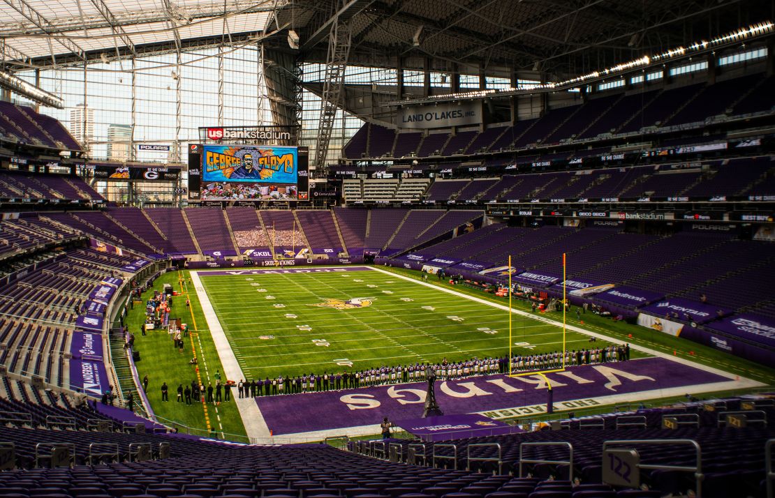 The Minnesota Vikings stand with arms linked as the team pays tribute to George Floyd before the game against the Green Bay Packers at U.S. Bank Stadium on Sunday, September 13.